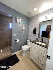 a bathroom with a toilet and a sink and a shower at Million-dollar Lake view on the Parker Strip! in Parker