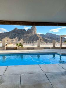 a swimming pool with a mountain in the background at Parker Strip pool house with game room! in Parker