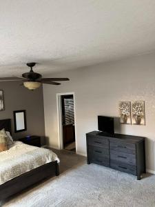 a bedroom with a bed and a ceiling fan at Parker Strip pool house with game room! in Parker
