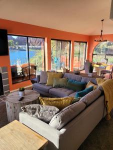 a living room with two couches and a table at Riverfront Escape with boat dock! in Parker