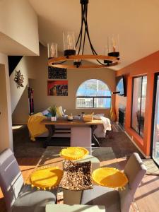 a living room with a dining room table and chairs at Riverfront Escape with boat dock! in Parker