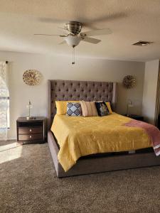 a bedroom with a large bed and a ceiling fan at Riverfront Escape with boat dock! in Parker