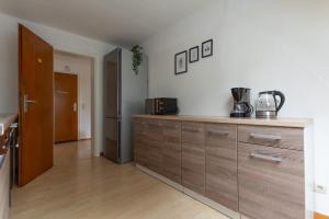a kitchen with wooden cabinets and a refrigerator at T&K Apartments - 3 Room Apartment in Mülheim an der Ruhr