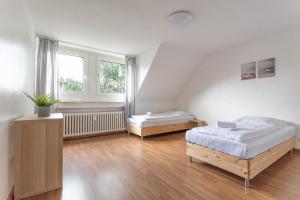una camera con due letti e una finestra di T&K Apartments - 3 Room Apartment a Mülheim an der Ruhr