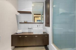 a bathroom with a sink and a glass shower at 347 Paradiso Kingscliff Beach 3 Bedroom Private Rooftop in Kingscliff