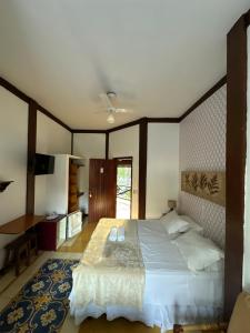 Cama ou camas em um quarto em Pousada Villa Nina