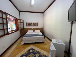 Cama ou camas em um quarto em Pousada Villa Nina