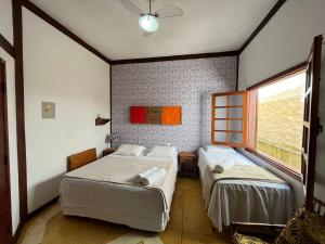 Cama ou camas em um quarto em Pousada Villa Nina