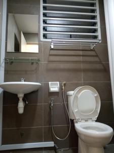 a bathroom with a toilet and a sink at LUXURY STAY - 2 ROOMS with CONDO Facility - Mount Austin JB - SPECIAL OFFER in Johor Bahru