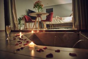 a bathroom with a bed and a bath tub with candles at Parronales de Los Boldos in Santa Cruz