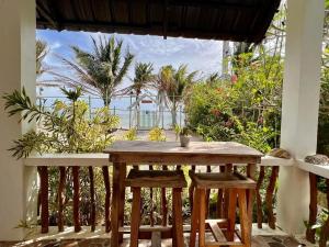 a table and chairs in a room with a view of the ocean at Happy's Homestay in Boracay