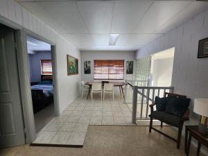 a living room with a table and chairs in a room at Central Comfy Holiday Unit in Cooktown