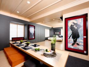 a dining room with a large painting on the wall at MIMARU TOKYO UENO OKACHIMACHI in Tokyo