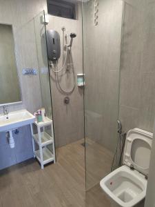 a bathroom with a shower and a toilet and a sink at Geo Sweet Homestay Kota Kemuning Bukit Rimau in Shah Alam