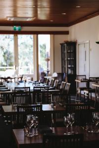 a dining room with wooden tables and chairs at Mendrinas at Brooklyn in Tumut