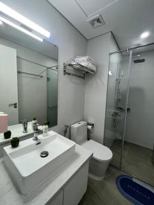 ein Bad mit einem Waschbecken, einem WC und einer Dusche in der Unterkunft 2S Homestay in Hạ Long