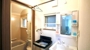 a bathroom with a sink and a toilet and a mirror at Dream Tree 札幌市电步行0分钟 超市步行1分钟 in Sapporo +38 photos