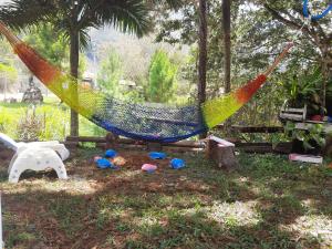 a hammock in a park with toys in the grass at SHERANPAZ in Oxapampa