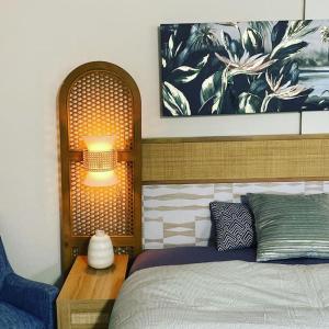 a bedroom with a bed and a table with a lamp at Seashore Waikiki studio 1 block from a beach No Resort Fees in Honolulu