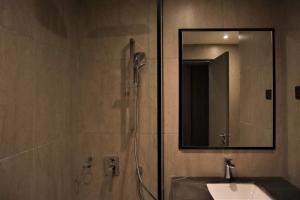 a bathroom with a shower with a sink and a mirror at KSL ESPLANADE HOTEL with HOT SPRING in Klang +37 photos
