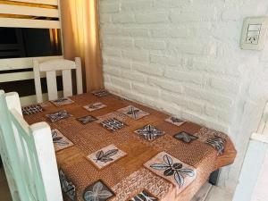 a table with a table cloth with butterflies on it at Cabañas Mirador del Dique in Termas de Río Hondo