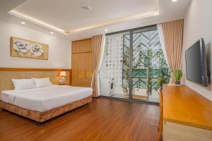 a bedroom with a bed and a large window at May Home Apartment Da Nang in Da Nang