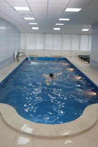 a person swimming in a large swimming pool at Sanotoriy Solotcha in Solotcha