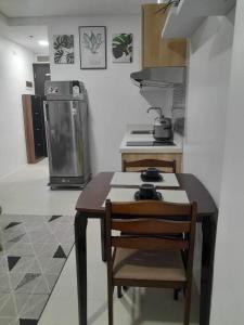 a kitchen with a table and chairs and a stove at The Hideaway at Citta Verde Primavera City in Cagayan de Oro