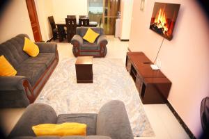 a living room with a couch and a fireplace at Beauty Homes Kilimani in Nairobi