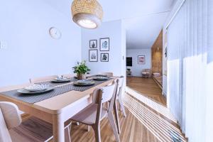 a dining room with a table and chairs at Three-Tree Villa-Central Location in Vancouver +29 photos