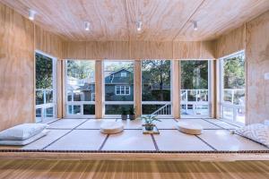 a room with a large window with two pillows at Three-Tree Villa-Central Location in Vancouver