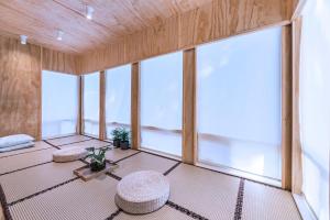 an empty room with two stools and large windows at Three-Tree Villa-Central Location in Vancouver