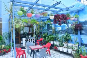 a patio with colorful chairs and tables and plants at Shreshth Home Stay - Best Family Accommodation - 3km from Har Ki Pauri, Haridwar, Uttarakhand in Haridwār