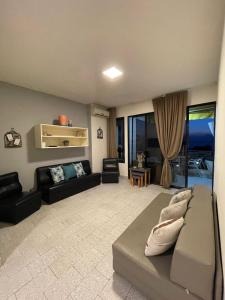 a living room with a couch and a living room with at Chalet in Jounieh, pool, amazing sea view, wifi Maameltein 