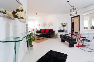 a living room with black and white furniture at Chic 3BR Apt w Parking on the Beach by Sea N' Rent in Tel Aviv