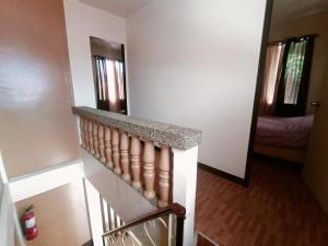 a room with a staircase and a hallway with a bedroom at Raymundo Residence in Dumaguete