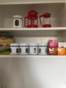 a kitchen shelf with food items on it at Horseinaround in Cambridge