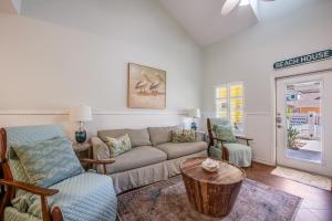 a living room with a couch and chairs and a table at Pirates Bay #118 The LUV Shack poolfront townhome in Port Aransas