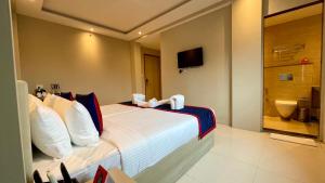 a hotel room with a bed and a bathroom at Zip By Spree Hotels Bhopal in Bhopal