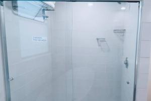 a shower with a glass door in a bathroom at Secure, central and quiet apartment work or travel in Mexico City +12 photos