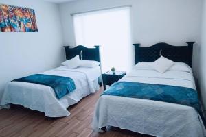 a bedroom with two beds and a window at Secure, central and quiet apartment work or travel in Mexico City