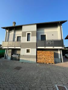a large house with a balcony and a brick wall at IL Sole in Caselle Torinese
