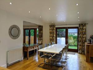 a dining room with a white table and chairs at Detached 4 Bedroom Luxury Home in Halifax