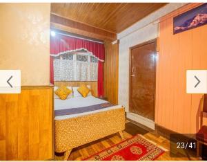 a bedroom with a bed and a window and a door at Dil of Darjeeling by StayApart in Darjeeling +15 photos