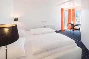 Postel nebo postele na pokoji v ubytování Trip Inn Hotel Astoria