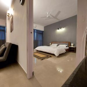 a bedroom with a bed and a room with at The skyline suite. in Lucknow