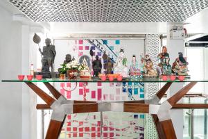 a glass table with a bunch of figurines on it at The Color Kata in Kata Beach