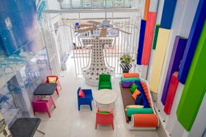 a room with colorful chairs and a table at The Color Kata in Kata Beach