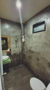 a bathroom with a shower and a toilet and a sink at Cheeva at pai ชีวา แอท ปาย in Pai