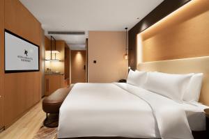 Rúm í herbergi á Langham Honor International Hotel Canton Fair Complex Branch - Free Shuttle to Canton Fair Complex During Canton Fair Period & Free Mini Bar